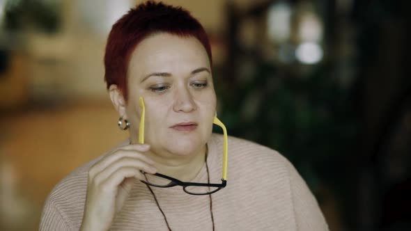 Tired Middleaged Woman Works Takes Off Glasses Shakes Her Head in Frustration