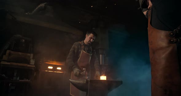 Two Blacksmiths Forge a Redhot Piece alt