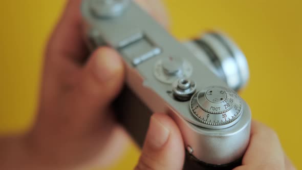 Close up Photographer Prepares Vintage Film Camera and Press the Button.