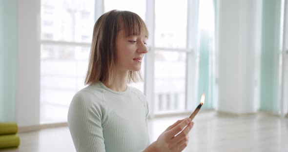 Woman Meditating with Palo Santo Holy Wood Relaxation Zen Practice in Studio alt