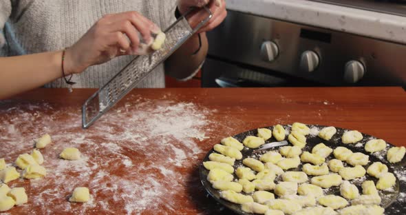 Young Girl is Making Homemade Potato Italian Gnocchi on the Table alt