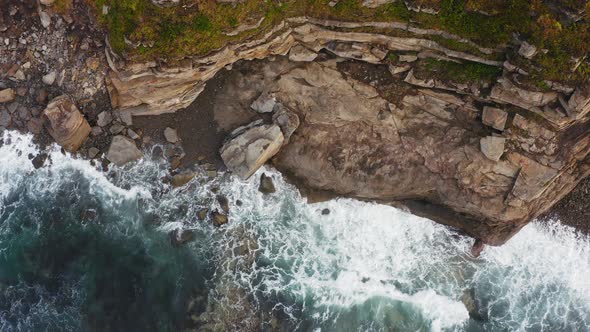 Aerial View of the Picturesque High Coastline Sharp Cliffs and Raging Sea alt