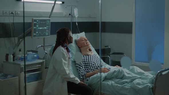 African American Doctor Talking to Sick Patient in Hospital alt