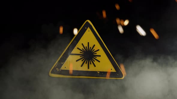 Laser Hazard Sign Over a Smoky Background