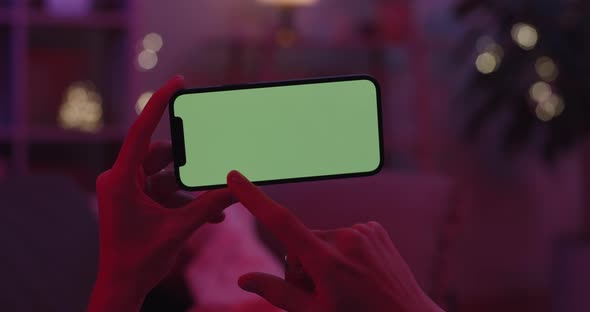Woman Doing Slide Gesture on Green Screen of Smartphone alt