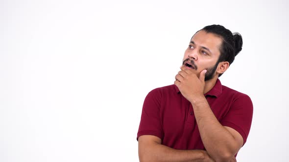 Indian young man thinking hard and pointing up alt