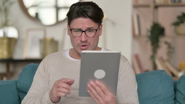 Failure for Middle Aged Man on Tablet at Home alt