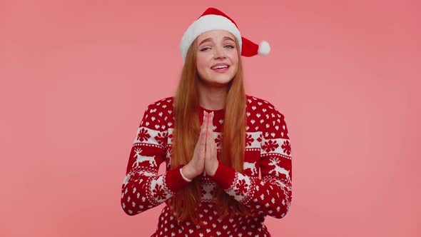 Girl in Christmas Santa Sweater Praying Looking Upward Making Wish Asking with Hopeful Expression alt