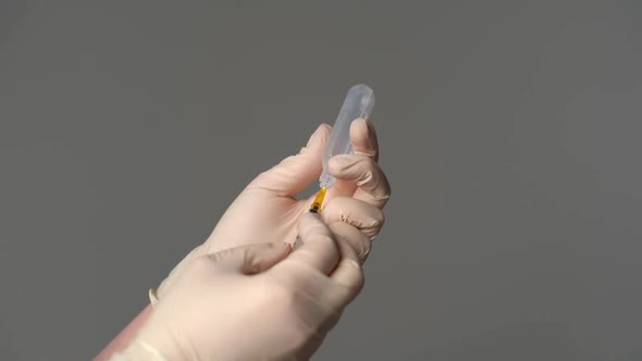 Extreme Closeup of Unrecognizable Doctor Wearing Latex Gloves Taking sarscoV2 Vaccine Dose From Vial alt