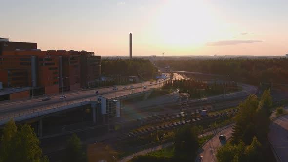 Awesome Aerial Shot of Cars Crossing a Bridge Over Railroad Tracks alt
