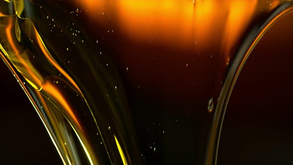 Super Slow Motion Shot of Flowing Golden Viscous Liquid at 1000Fps. alt