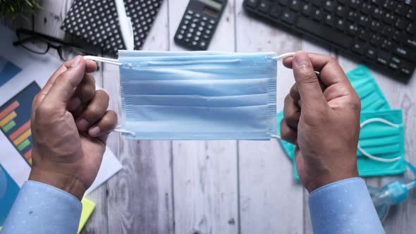 High Angle View of Businessman Holding Surgical Face Mask,  alt