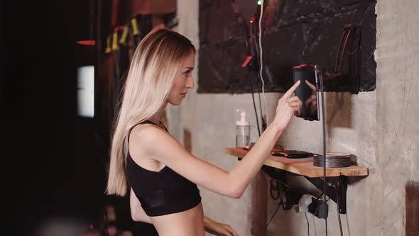 Woman Using Tablet Computer At Health Club alt