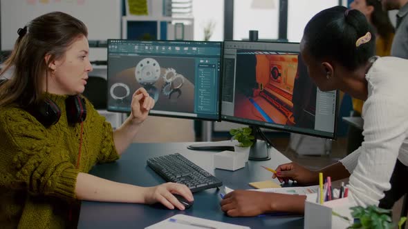 Gamer Creator Explaning to African Worker How Testing Game Level Interface alt