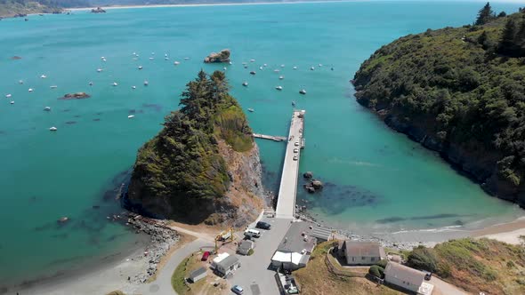 4K Drone flies above Trinidad Harbor and Pier with Ships Parked along coastline