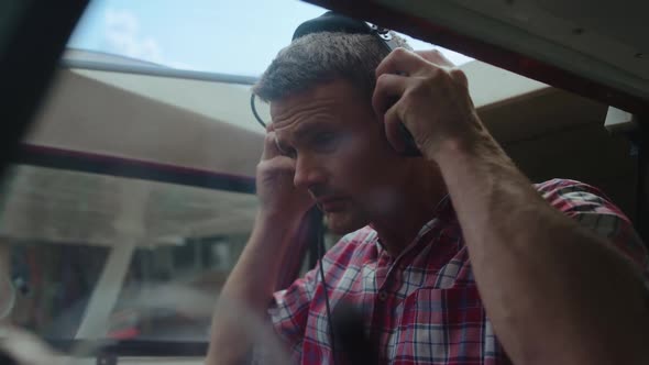 Airplane Pilot Preparing Flight Putting on Headphones Plane Cabin Close Up alt