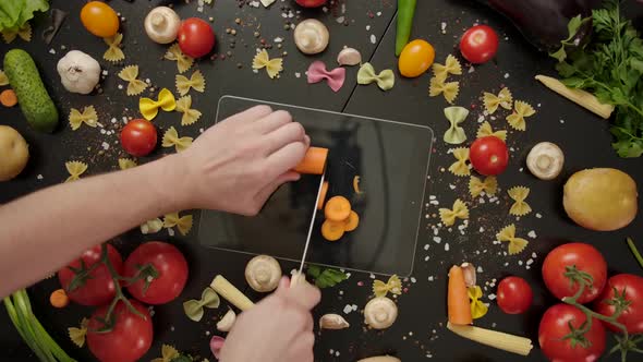 Crazy Cook Cutting Carrot on Digital Tablet, Damaging the Device. alt
