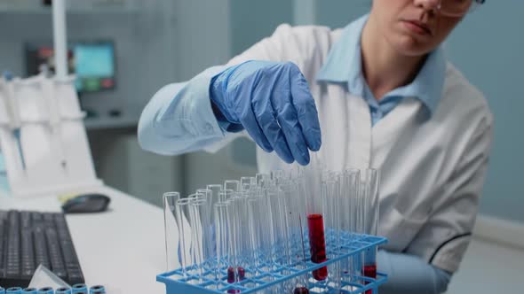 Portrait of Laboratory Scientist Analyzing Blood From Test Tube alt