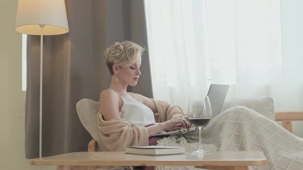 Woman Working on Laptop from Hotel Room during Vacation alt
