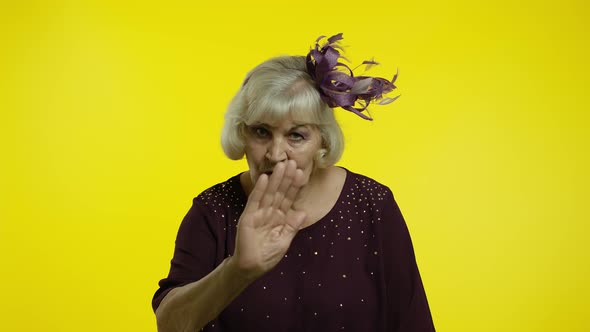 Senior Old Woman Showing Admonishing Finger Gesture, Disapproval Sign, Asking To Stop. Slow Motion alt