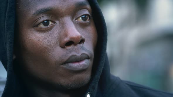 Young pensive hooded black african man staring into space, Stock Footage