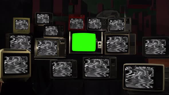 Retro TV turning on Green Screen Amidst Many Old TVs with Glitched Screens. 4K.