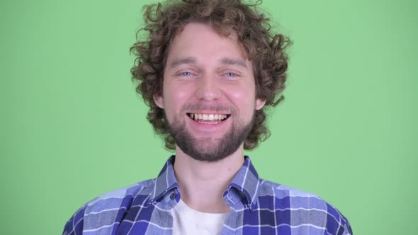 Face of Happy Young Bearded Hipster Man Smiling alt