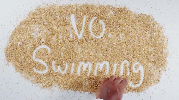 Hand Writing On Sand No Swimming