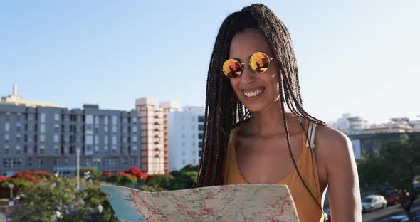 Bohemian mixed race young woman looking city map - Summer vacation, travel and lifestyle concept alt