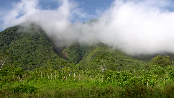 timelapse white puffy clouds covering the top of a dormant volcano in Asia 4k alt