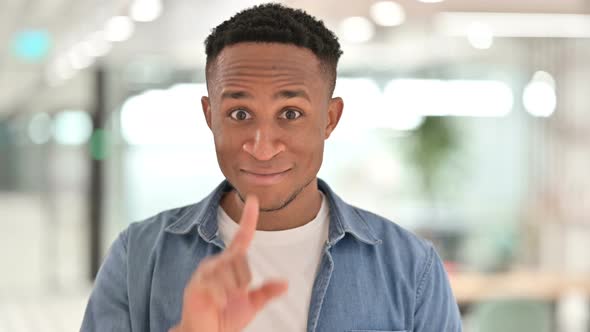 Portrait of Assertive Casual African Man Pointing and Inviting  alt