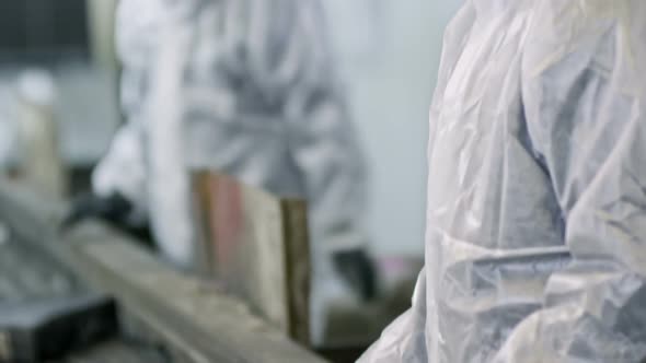 Workers Inspecting Waste on Conveyor Belt alt