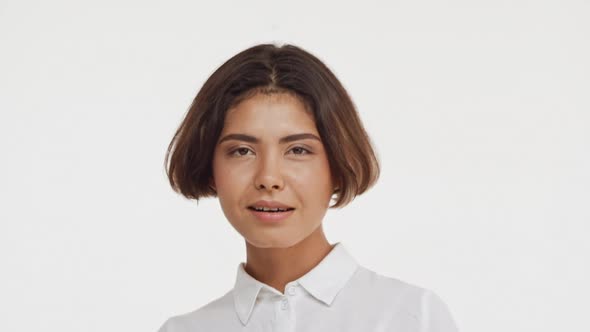 Young Beautiful Brunette East Asian Female in Shirt Flirting at Camera Smiling Showing Tongue Waving alt