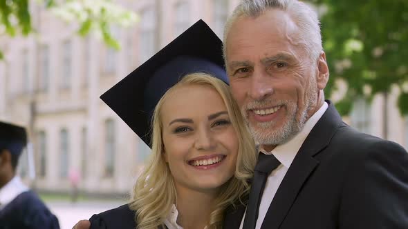 Happy Father Proud of His Clever Daughter Graduating From University With Honors alt