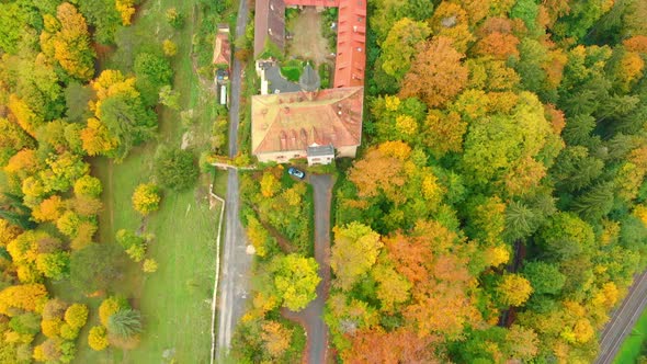 Aerial Drone shot of a castle in vibrant autumn colours 4K alt
