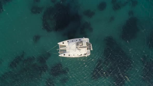 Aerial view of a catamaran anchored in Aegean sea, Greece. alt