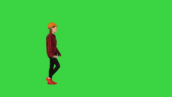 Asian Engineer Walking with Blueprints on a Green Screen Chroma Key