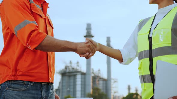 confident engineer and contractor successful business achievement hand shaking together alt