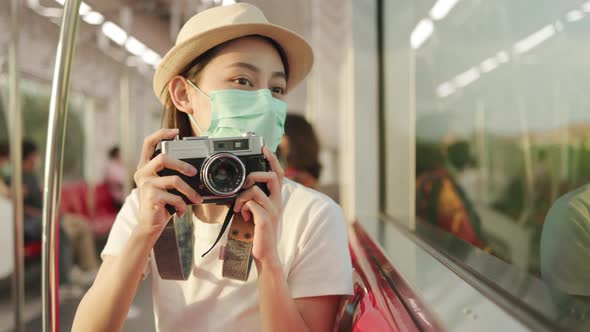 Backpack and hat at the train station with a traveler. alt