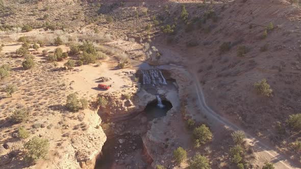 Flying in towards water fall on LaVerkin Creek viewing dirt road alt