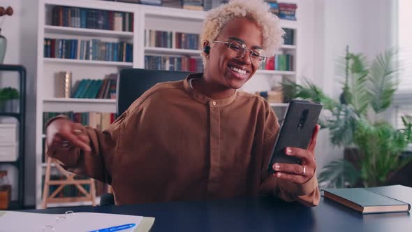 Joyful Young African Woman Make Answer Video Call on Phone at Home Office alt