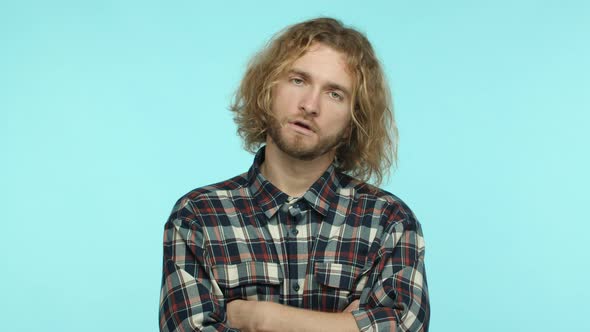 Slow Motion of Tired Skeptical Man with Blond Wavy Hair and Beard Exhale Annoyed and Cross Arms on