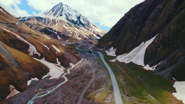 Beautiful Drone Shot of a Road in Kazbegi and Mountains Georgia alt