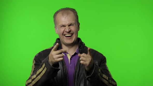 Man Holding Belly and Laughing Out Loud with Tears, Feeling Carefree Joyful After Hearing Funny Joke alt