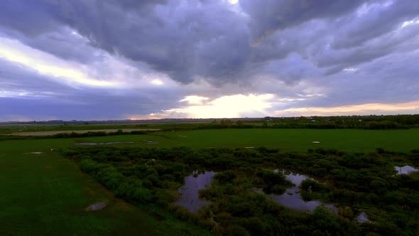 Wetlands surrounded by cultivated farmland alt