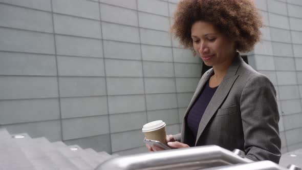 Businesswoman using smart phone and on the move