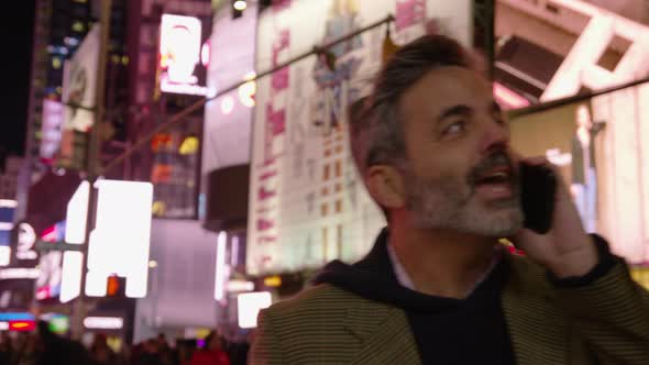 Man talking on cell phone in Times Square, New York City