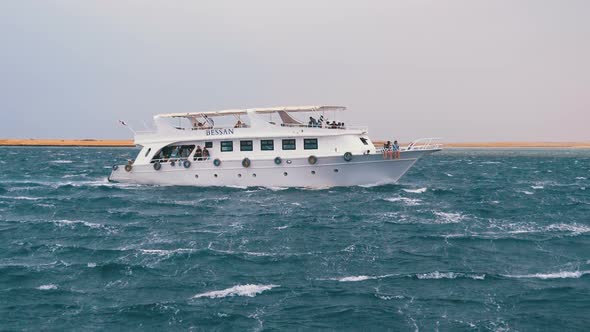 Pleasure Boat with Tourists Is Sailing in the Storm Sea. Egypt, Sharm El Sheikh alt