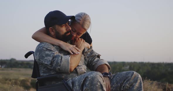Wife Hugging Wheelchaired Husband alt
