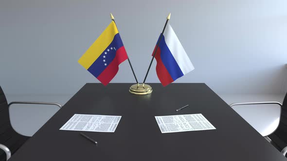 Flags of Venezuela and Russia and Papers on the Table alt